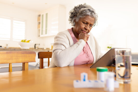 Senior african american women using tablet and sitting and the table