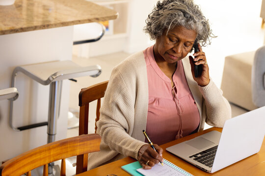 Senior african american women using laptop and phone