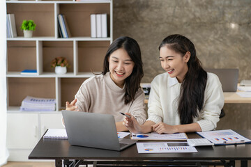 2 cute Asian women working in the finance office concept accountant