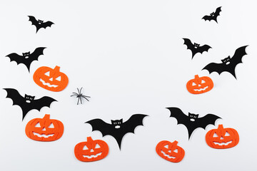 Halloween decor on a white background. Pumpkin and bat, place for an inscription.