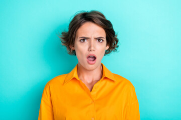 Portrait of astonished unhappy upset girl with bob hairstyle dressed yellow blouse blaming look isolated on turquoise color background - obrazy, fototapety, plakaty