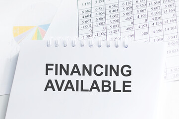 text Financing Available on a notepad on the reporting table. Financial concept