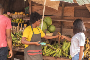 african lady shopping for plantain in the market