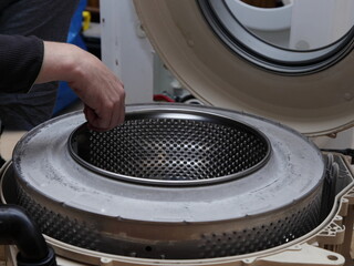 Front load washing machine repair bearings test with hand