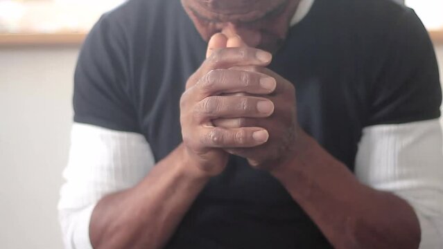man praying to god with hands together on grey background stock footage