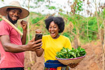 african farmers checking their phone rejoice