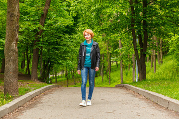 beautiful girl walking in summer park