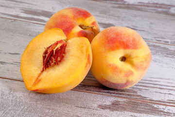 View of a bunch of peach fruits on wooden background.