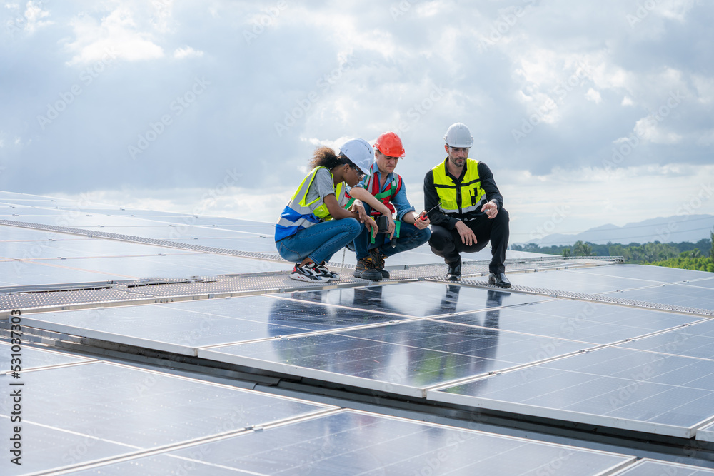 Aufkleber engineers checking the operation of the system solar cell on an building in an residential area,phot