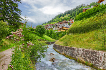 Fototapeta na wymiar The Rio Gardena stream near Santa Cristina Valgardena. South Tyrol, Italy