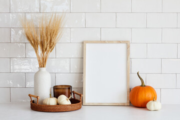 Autumn still life. Nordic kitchen interior with picture frame mockup, tray with vase of dry wheat,...