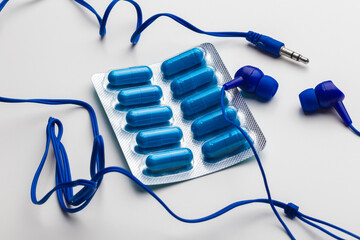 music addict concept blue pills and blue headphones