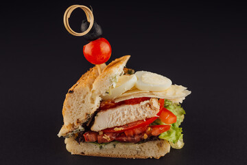 Chicken sandwich with boiled eggs, tomatoes and cheese
