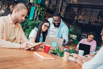 Photo of pretty confident businesspeople having upgrading courses indoors workplace workshop loft