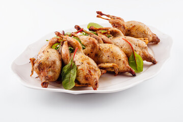 Tasty fried quail on white plate