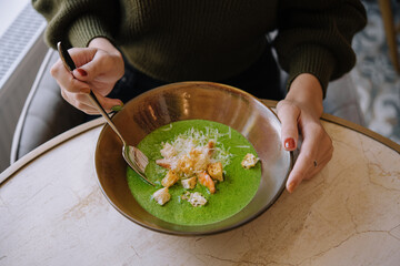 Broccoli green cream soup with shrimps