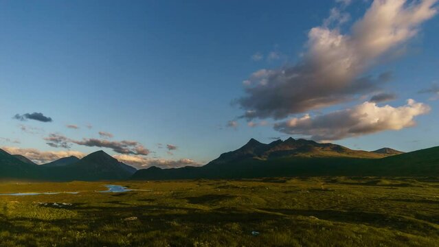 Time lapse of a golden sunset over the mountains of Cuillins on Skye, Scotland, United Kingdom