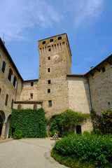 Fototapeta na wymiar tower and of the palace Castle, Castello of Montechiarugolo, Parma, Italy with plants and monuments, doors, and windows