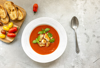 Tomato soup with bread, fresh, crunchy vegetables, and herbs. It is served cold with hot bread. Spanish gazpacho recipe.