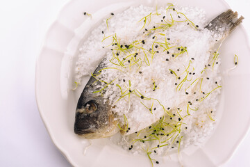 Fish baked in salt on plate