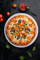 vegetarian pizza with zucchini, eggplant, mushrooms and tomato