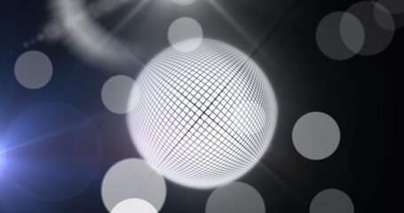 Fototapeta na wymiar Image of mirrorball and white bokeh lights on dark background