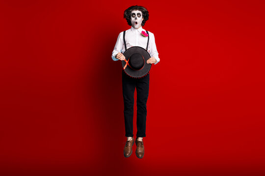Full length body size view of his he handsome skinny tall creepy scary spooky amazed stunned gentleman jumping up catrina carnival celebratory isolated bright vivid shine vibrant red color background