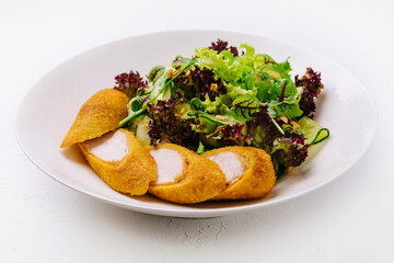 Chicken nuggets on a plate on white