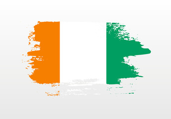 Modern style brush painted splash flag of Cote dIvoire with solid background