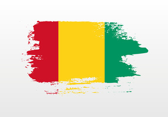 Modern style brush painted splash flag of Guinea with solid background