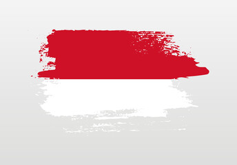 Modern style brush painted splash flag of Monaco with solid background