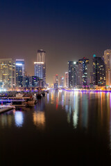 Fototapeta na wymiar Dubai city at night, reflection of lights on the surface of the water. urban landscape