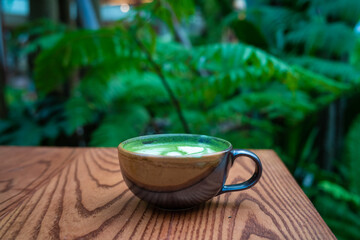 Hot matcha latte art on wood table japanese aroma drink