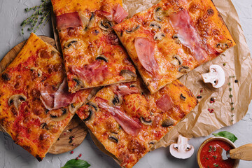 Long pizza mix lies on a wooden table