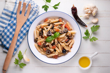 Sicilian pasta with olives, tomato and olive oil. Traditional recipe from the island of Sicily.