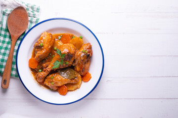 Chicken with vegetable sauce, carrots, peas and potato. Traditional Spanish dish recipe.