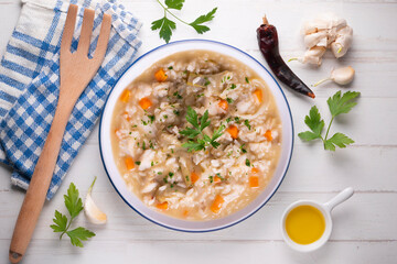 Soupy rice with artichokes and carrots. Typical Spanish gastronomy platter.