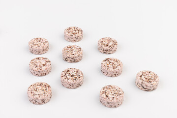 Heap of medicine colored pills, tablets on a white background