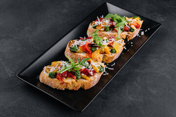 bruschetta with roasted peppers, pesto and parmesan cheese