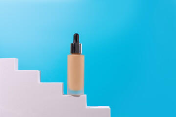 Cosmetic liquid foundation nude cream bottle mockup on white podium pedestal. Beige concealer base...