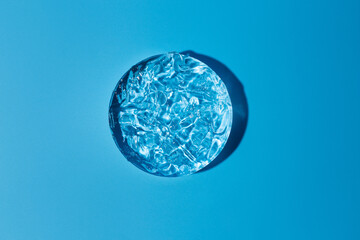 Empty white circle with moisturized gel on podium on transparent clear blue background. Abstract...