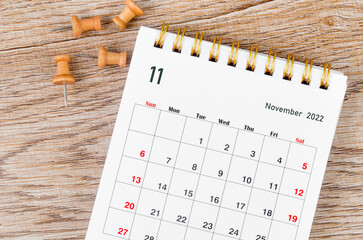 The November 2022 Monthly desk calendar for 2022 year and wooden push pin.