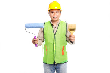 young asian man wearing yellow hard hat and work safety clothing holding paint roller brush isolated on white background