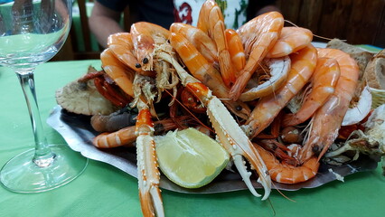 A large plate of different seafood in an old pub in Madrid, Seafood platter with crabs, shrimps, crabs and crawfish
