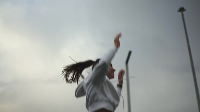 girl in a white suit jumping high