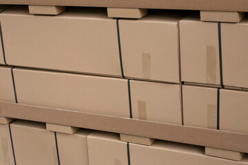 Cardboard boxes laying in warehouse close up. Forklift as a backdrop. Logistics, distribution and delivery concept. mockup