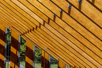 Exposed wooden rafters supporting glass roof. Open plan eco-friendly property with timber roof...
