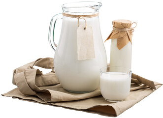 Fresh organic milk in glass and jug on rustic wooden table on nature background.