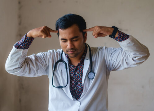 Concept Of South Asian Doctor Is Being Irritated By Something, Medical Student In A Stressful Gesture 