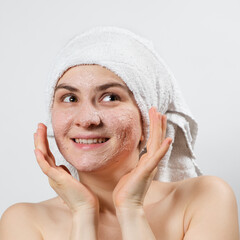A beautiful young woman applied a scrub or mask to her face, facial skin care, skin cleansing